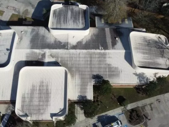 image of a commercial building's roof before a professional roof washing by A-1 Window Washers
