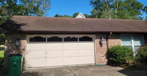 image of a home garage and roof before a professional wash by A-1 Window Washers